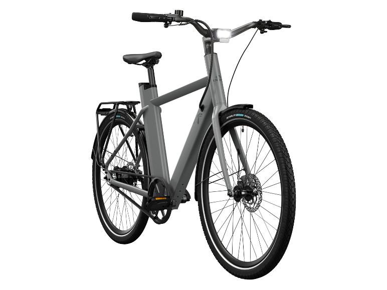 Crivit e-bike Urban 3.0 X in grijs van voren gezien, met koplamp in het frame en bagagedrager